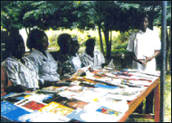 Photo of residents surrounding a table of books